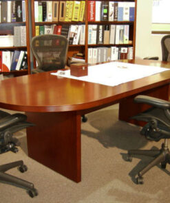 cherry conference table and four gray chairs with white paper on top and cherry wood box